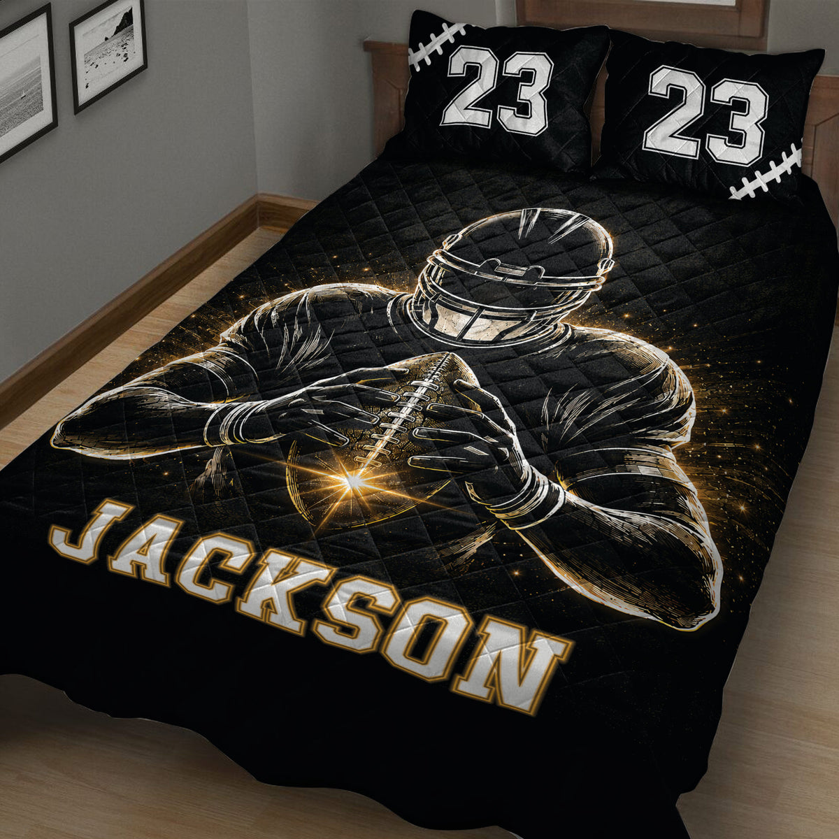 Angled bedroom view of a black football quilt blanket featuring a helmeted player and glowing gold accents