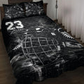 Black hockey quilt blanket displayed on a bed with goalie mask, skates, and bold sports artwork