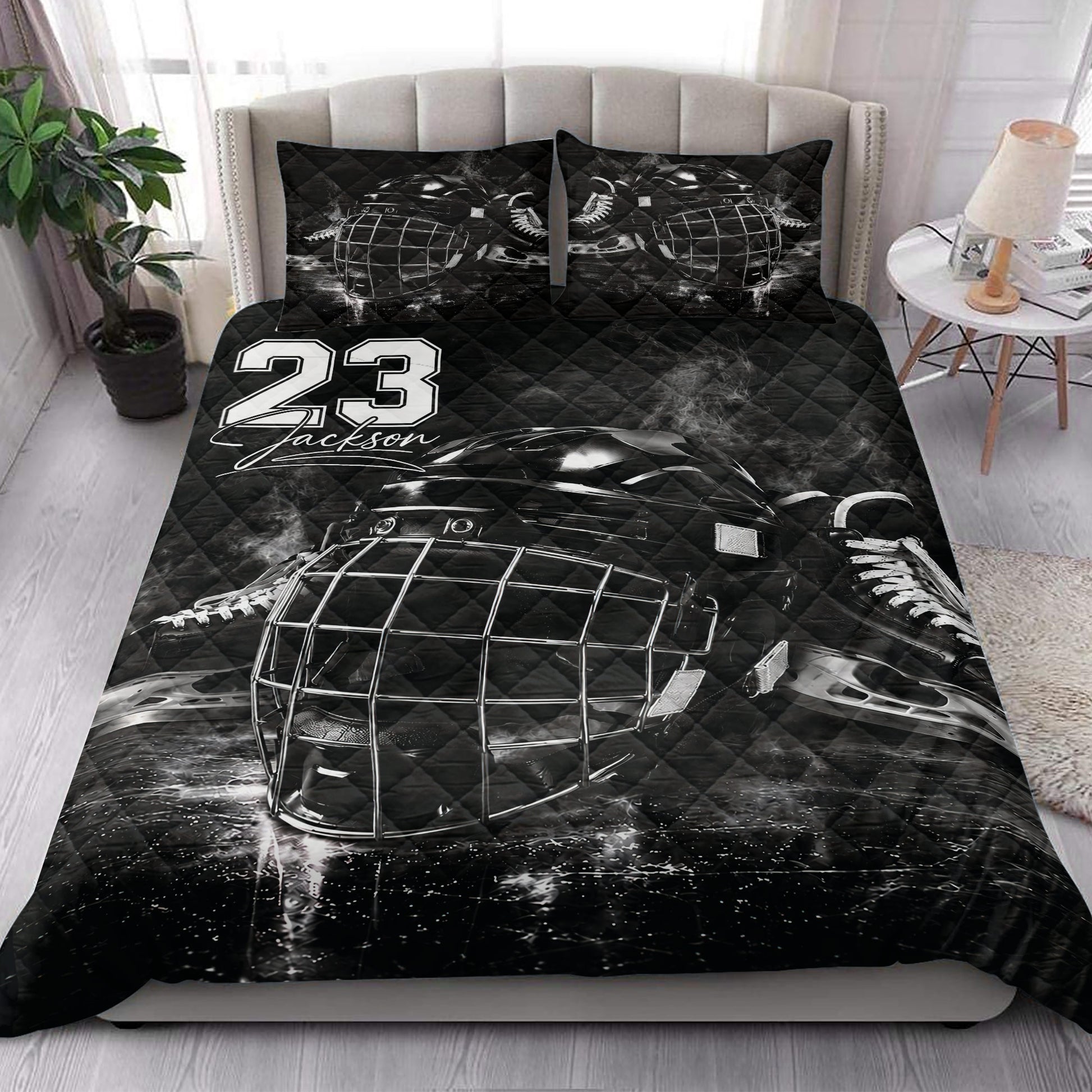 Black hockey quilt blanket styled in a modern bedroom with dramatic goalie mask artwork