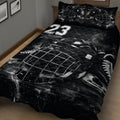 Angled bedroom view of a black hockey quilt featuring skates, goalie gear, and ice-inspired graphics