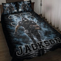 Black and blue football quilt blanket displayed on a bed with a running football player design
