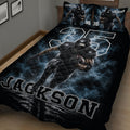 Close bedroom view of a football quilt blanket featuring a running player and bold athletic graphics