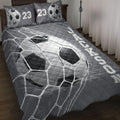 Soccer quilt blanket spread across a bed with goal net and soccer ball artwork in charcoal gray