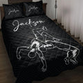 Black wrestling quilt blanket displayed on a bed with dramatic grappling artwork