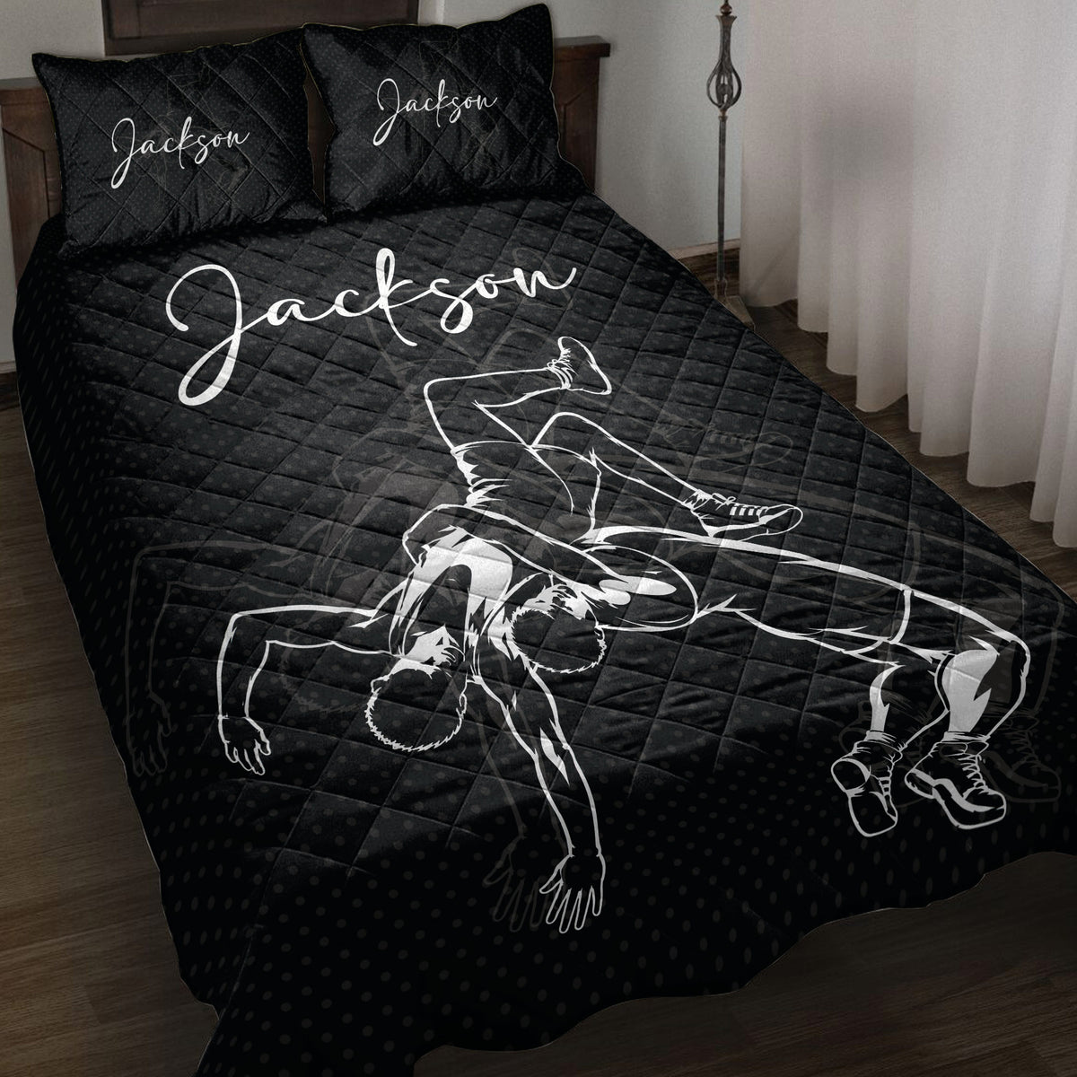Black wrestling quilt blanket displayed on a bed with dramatic grappling artwork