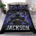 Football quilt bedding set styled in a bedroom with bold blue and black sports artwork