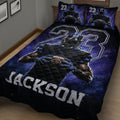 Football player quilt blanket displayed on a bed in a dark blue bedroom decor setting