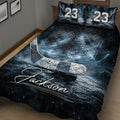 Close bedroom view of a dark blue hockey quilt blanket featuring icy rink textures, hockey stick, and puck