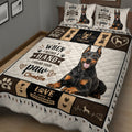 Close bedroom view of a Doberman quilt blanket with love-themed panels, hearts, bones, and paw prints