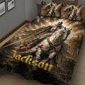 Close view of Knights Templar quilt blanket with armored rider, castle scenery, and red cross details