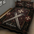 Close angled view of Knights Templar quilt bedding with crossed swords, shields, crosses, and gold flourishes