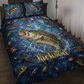 Fishing quilt blanket displayed on a bed with bass, fishing lures, reels, and deep blue water artwork