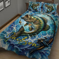 Close view of a fishing quilt blanket featuring a large bass, lure, fishing rod, and blue splash design