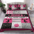 Cheerleading quilt bedding styled in a bright bedroom with pink, black, white, and gray sports artwork