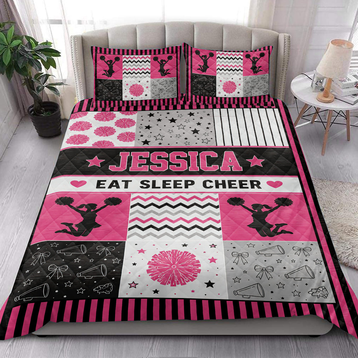 Cheerleading quilt bedding styled in a bright bedroom with pink, black, white, and gray sports artwork