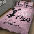 Pink cheerleading quilt blanket in a cozy bedroom featuring black pom-pom cheerleader artwork