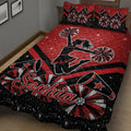 Red cheerleading quilt blanket displayed on a bed with pom-poms, megaphones, stars, and cheerleader artwork