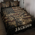 Deer quilt blanket displayed on a bed with detailed buck artwork, antlers, stars, and rustic patriotic colors