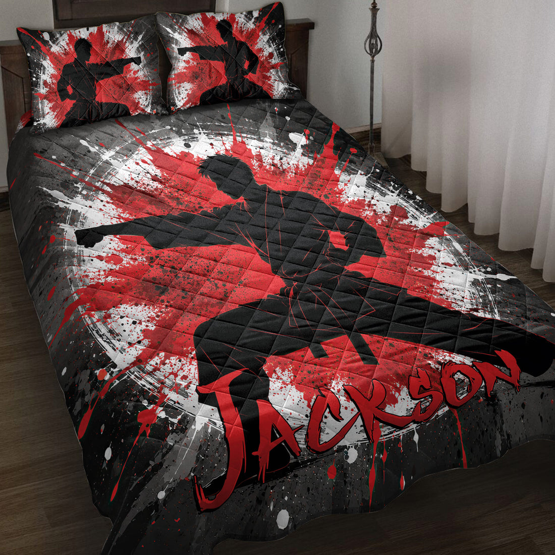 Karate quilt blanket displayed on a bed with martial artist silhouettes and bold red, black, and white artwork
