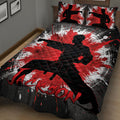 Angled bedroom view of a karate quilt blanket featuring a kicking martial artist and bold red artwork
