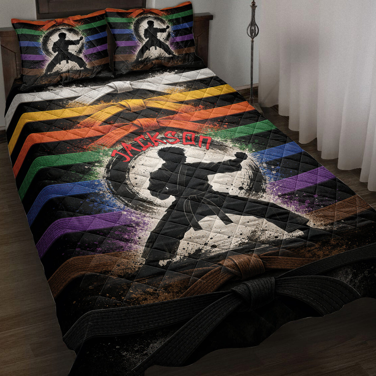 Karate quilt blanket displayed on a bed with martial artist silhouettes, colorful belts, and bold black artwork