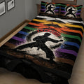 Close bedroom view of a karate quilt blanket featuring a martial artist silhouette and vibrant belt colors
