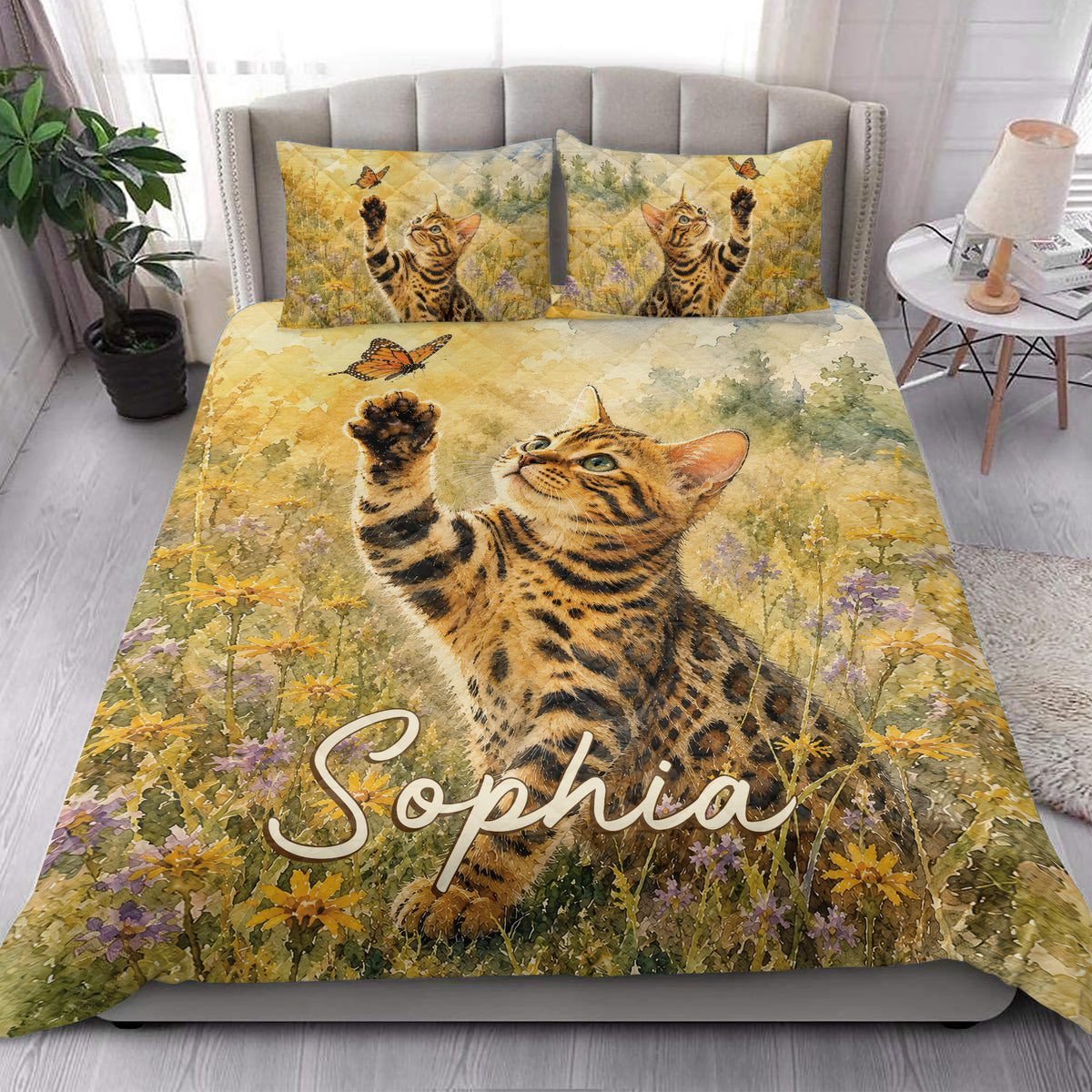 Bengal cat quilt blanket styled on a bed with butterfly and meadow artwork