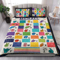 Sign language alphabet quilt blanket displayed in a bright bedroom with colorful hand sign artwork