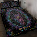 Black sign language quilt blanket with colorful mandala hand artwork displayed on a bedroom bed