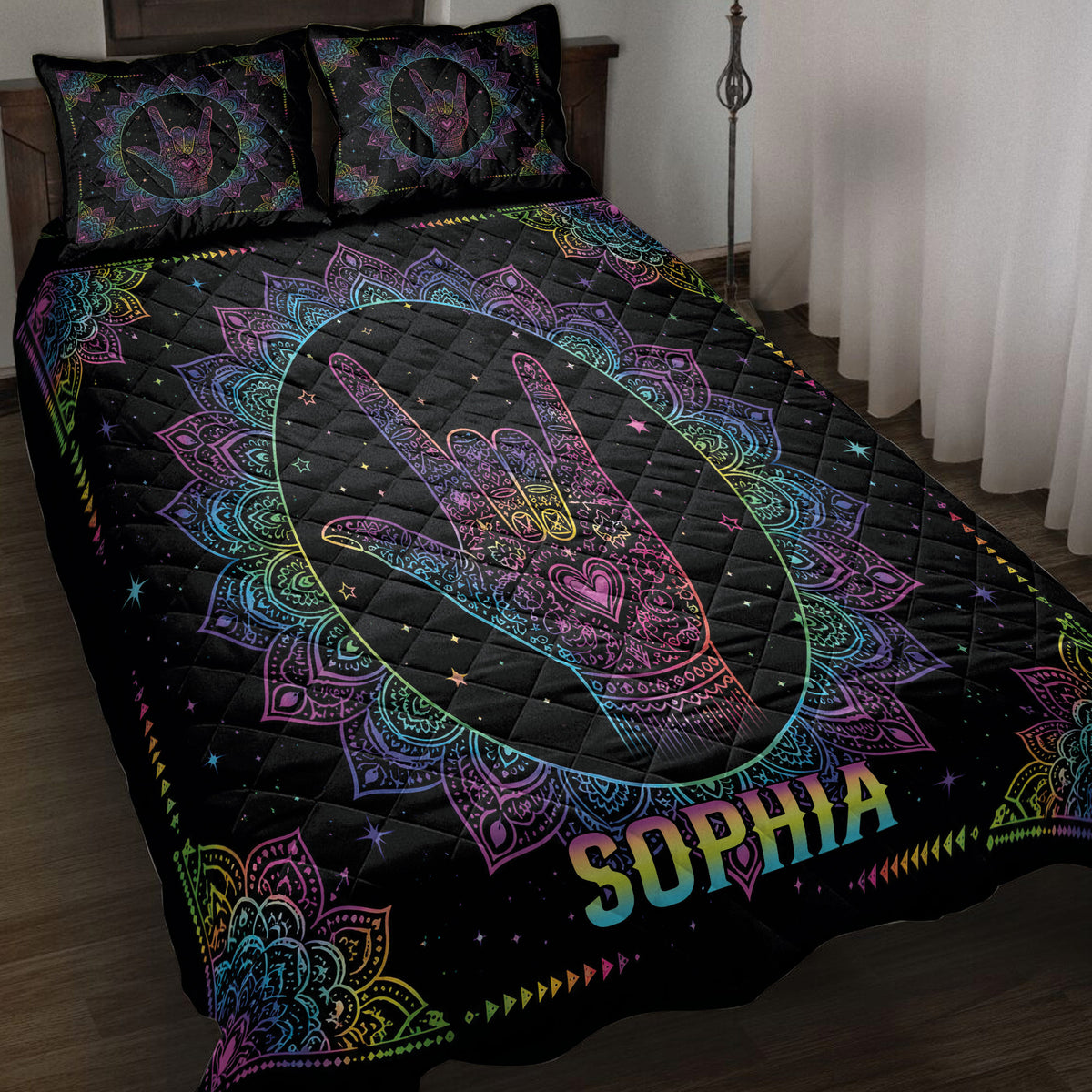 Black sign language quilt blanket with colorful mandala hand artwork displayed on a bedroom bed