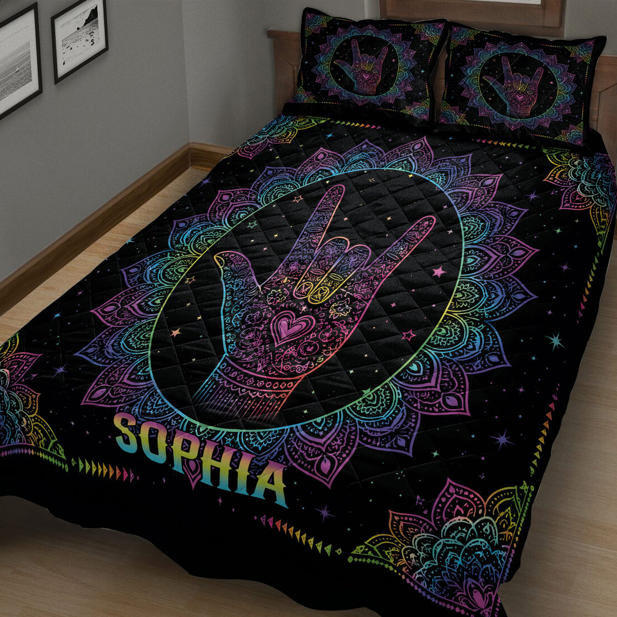 Close bedroom view of a black sign language quilt with rainbow mandala artwork and hand symbol