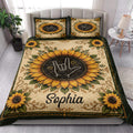 Sign language sunflower quilt styled across a bright bedroom with coordinated decorative pillows