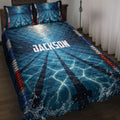 Blue swimming pool lane quilt bedding set styled on a bed with wave splashes and red, white, and blue accents
