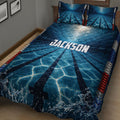 Close bedroom view of blue swimming pool lane quilt bedding with dramatic water and splash graphics