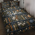 Book-themed quilt bedding set with floral bookshelves in a dark navy bedroom setting