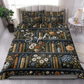 Literary floral quilt bedding styled on a bright bedroom bed with matching book-patterned pillows
