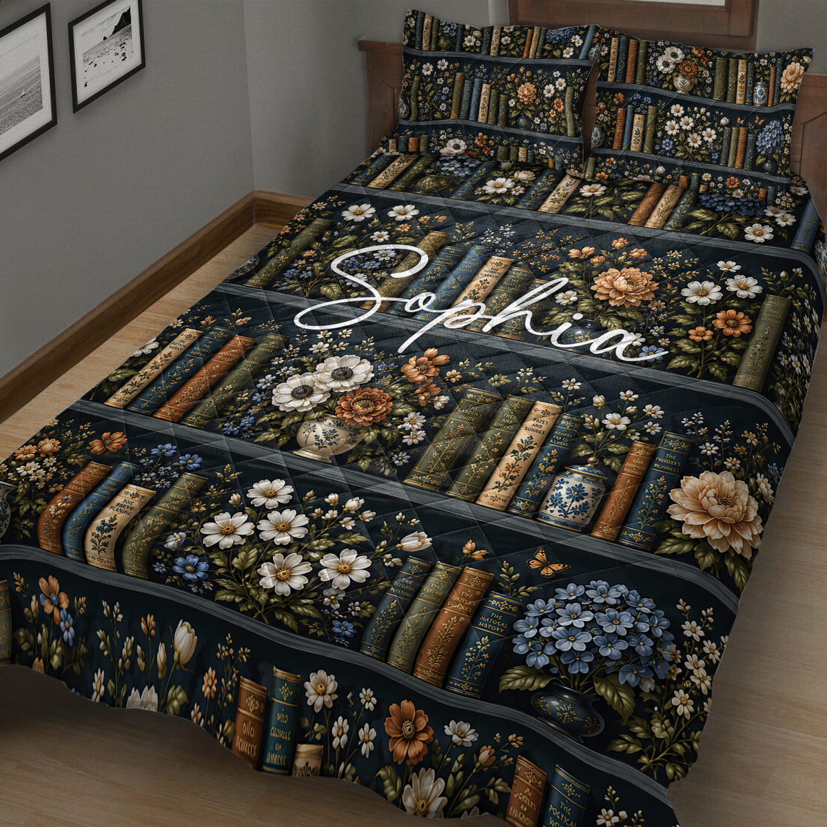 Close bedroom view of a dark book-themed quilt with flowers, books, and decorative vases