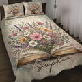Book-themed quilt blanket displayed on a bed with an open book and colorful wildflower bouquet artwork