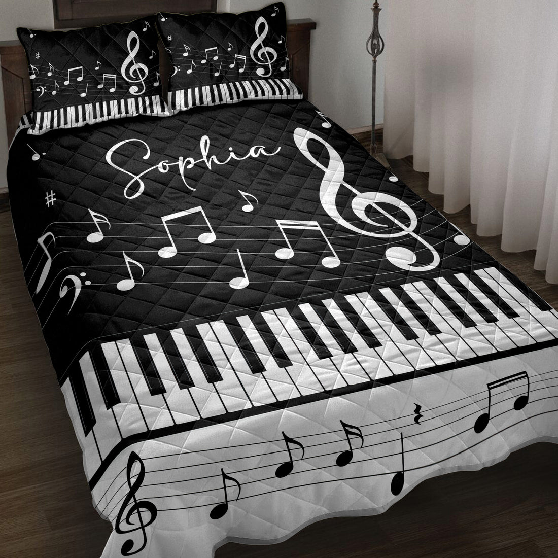 Black and white piano quilt blanket displayed on a bed with musical notes, treble clefs, and keyboard artwork
