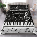 Piano music quilt styled in a bright bedroom with keyboard keys, musical notes, and treble clef artwork