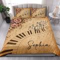 Piano quilt bedding styled in a bright bedroom with floral accents, musical notes, and piano key artwork
