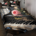 Piano quilt blanket displayed on a bed with rose artwork, black and white keys, and dark elegant styling