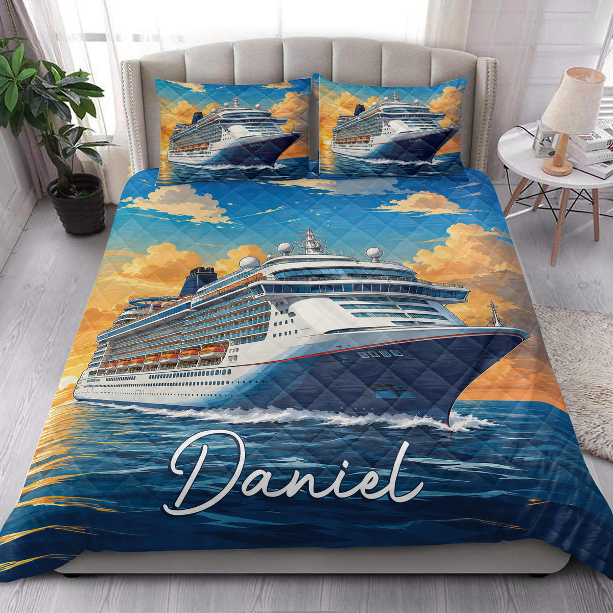 Cruise ship quilt bedding styled in a bright bedroom with blue water and golden sky artwork