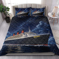 Cruise ship quilt blanket styled on a bedroom bed with ocean liner artwork