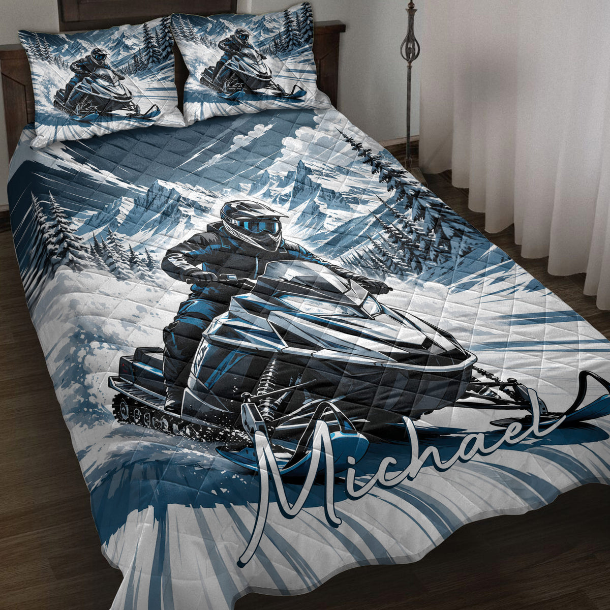Snowmobile quilt bedding displayed on a bed with blue mountain scenery and rider artwork