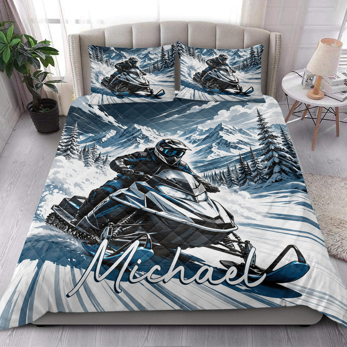 Snowmobile quilt bedding styled in a bright bedroom with snowy mountain and rider artwork