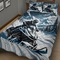 Snowmobile quilt spread across a bed with bold blue mountain landscape and winter riding artwork