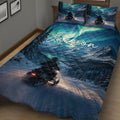 Snowmobile quilt blanket displayed on a bed with winter mountain scenery, forest trees, and a rider on a trail