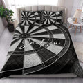 Dartboard quilt blanket displayed on a bright bedroom bed with matching black and white pillows