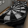 Close bedroom view of a black and white dartboard quilt blanket with bold target artwork